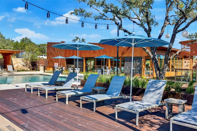 wooden deck with a community pool