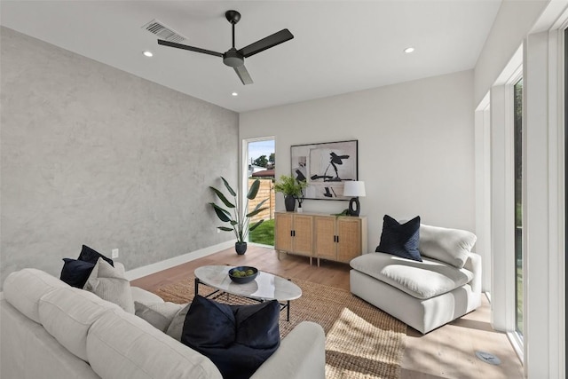 living room featuring ceiling fan and wood-type flooring