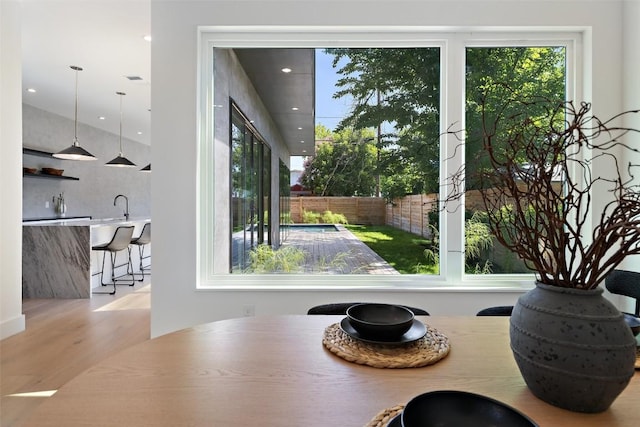 dining room featuring sink and light wood-type flooring