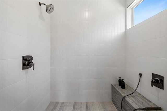 bathroom with a tile shower