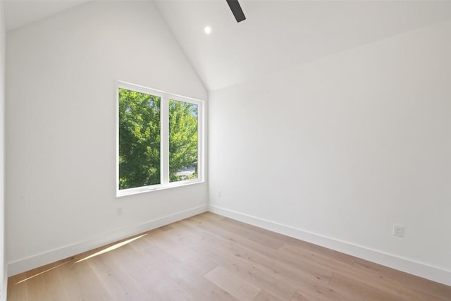 unfurnished room with high vaulted ceiling and light hardwood / wood-style flooring