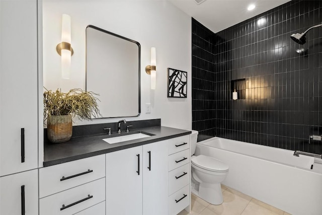 full bathroom with toilet, vanity, tile patterned floors, and tiled shower / bath