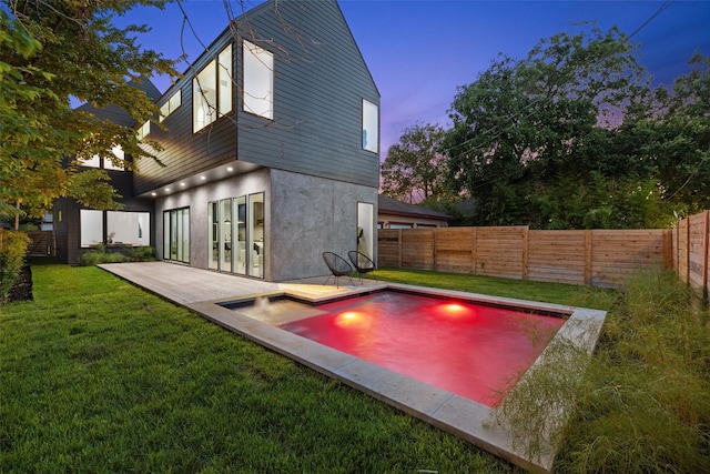 exterior space featuring a patio area, a fenced in pool, and a yard