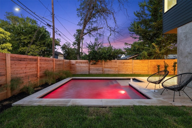 view of pool at dusk