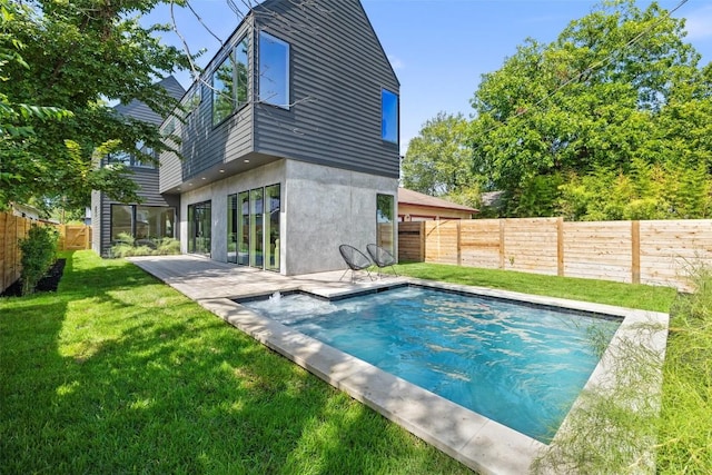 exterior space featuring a lawn, a patio area, and a fenced in pool