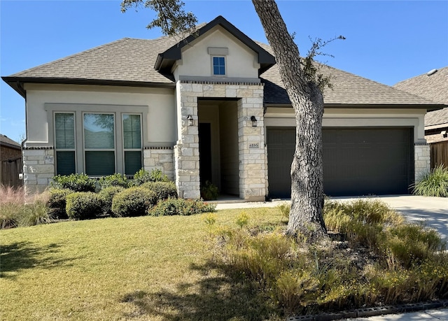 view of front of property featuring a front yard and a garage