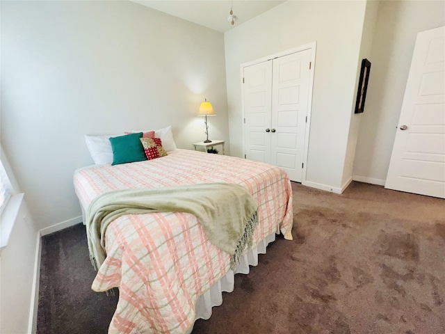 bedroom with a closet and dark colored carpet