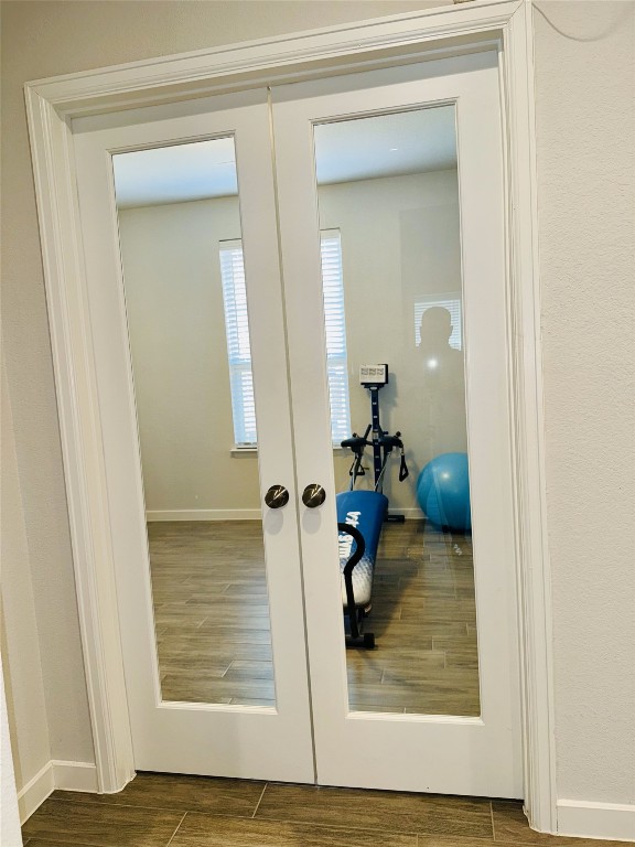 doorway to outside featuring french doors and dark hardwood / wood-style floors