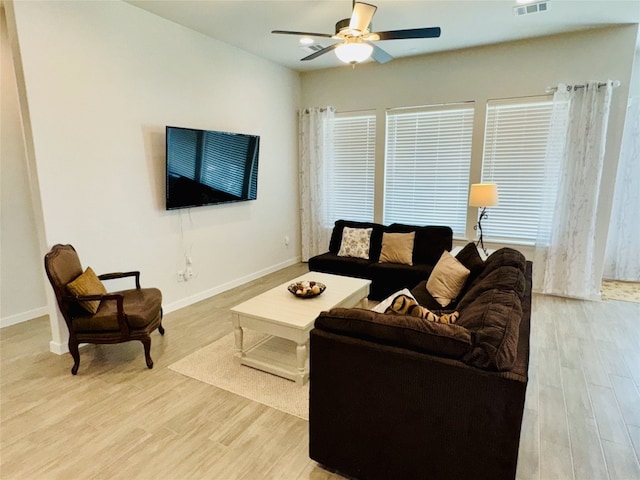 living room featuring light hardwood / wood-style floors and ceiling fan