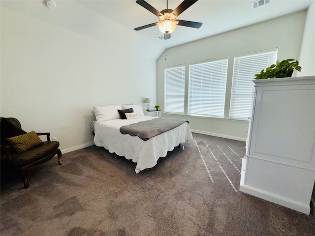 bedroom with vaulted ceiling, dark colored carpet, and ceiling fan