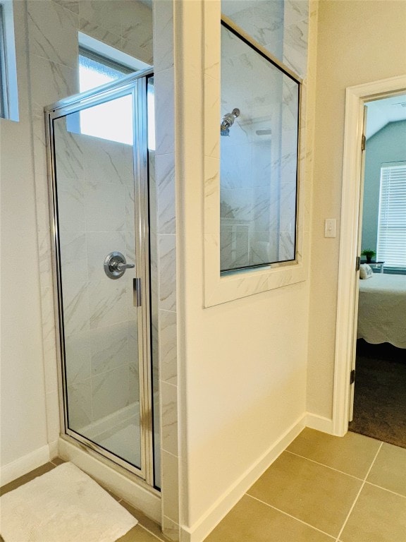 bathroom featuring tile patterned floors and a shower with shower door