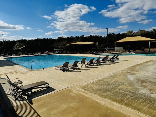 view of swimming pool with a patio area