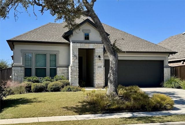 view of front facade with a front yard and a garage