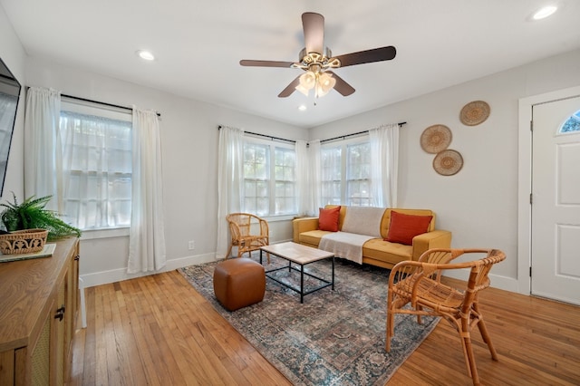 living room featuring ceiling fan and light wood-type flooring