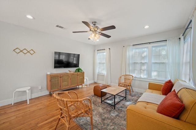 living room featuring ceiling fan and wood-type flooring