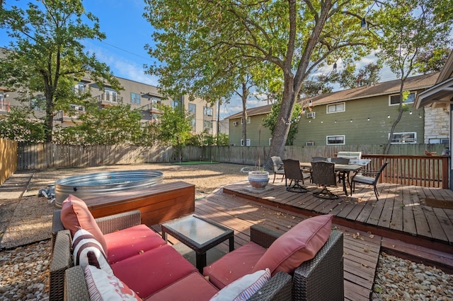 view of patio / terrace featuring an outdoor living space, a deck, and an outdoor hot tub