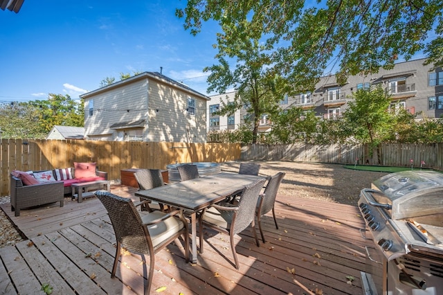 deck featuring outdoor lounge area and grilling area