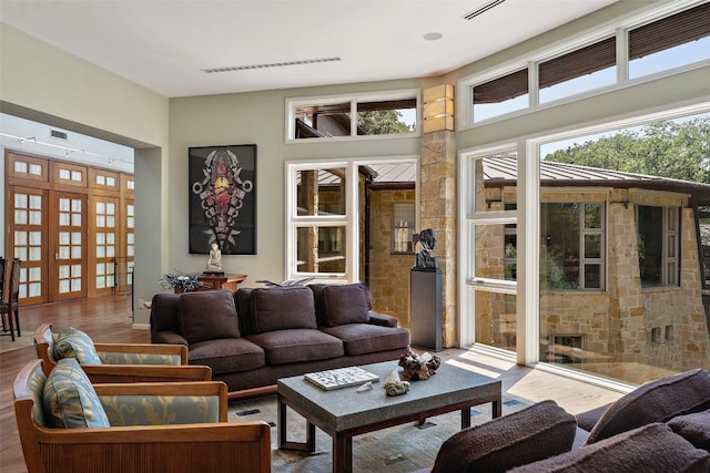 living room with french doors and hardwood / wood-style flooring