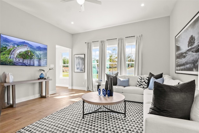 living room featuring light wood-type flooring and ceiling fan