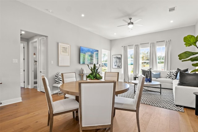 dining room with ceiling fan and light hardwood / wood-style flooring