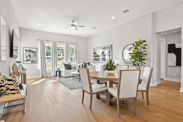 dining area with light wood-type flooring and ceiling fan