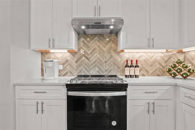 kitchen featuring electric range, white cabinetry, and decorative backsplash