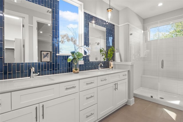 bathroom featuring vanity, tile patterned floors, decorative backsplash, and a shower with shower door