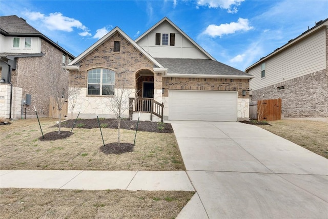 view of front of property with an attached garage, brick siding, fence, driveway, and roof with shingles