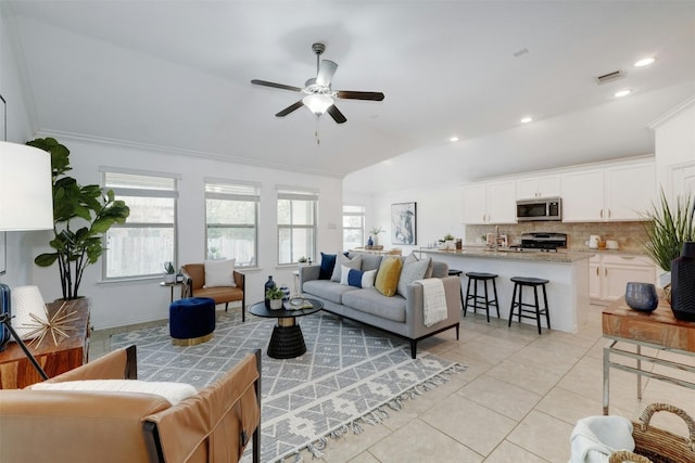 tiled living room featuring lofted ceiling, crown molding, sink, and ceiling fan