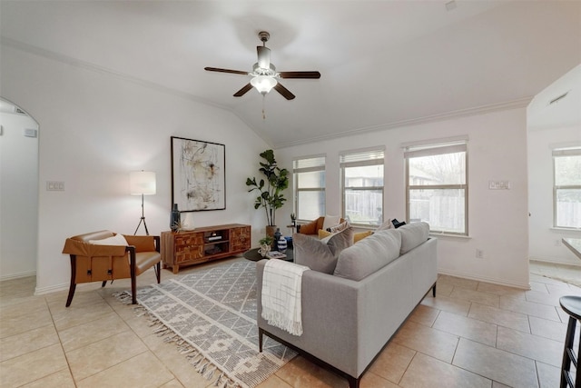 living room with lofted ceiling, ceiling fan, ornamental molding, and light tile patterned floors