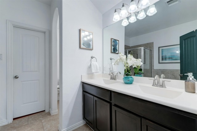 bathroom with vanity, tile patterned floors, and a shower with shower door