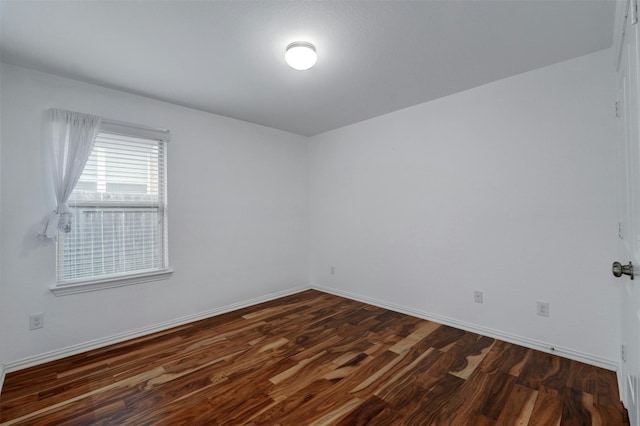 empty room with dark hardwood / wood-style floors