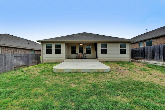 rear view of property featuring a patio area, a lawn, and ceiling fan