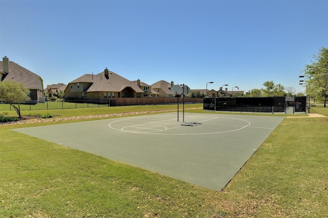 view of basketball court with a yard