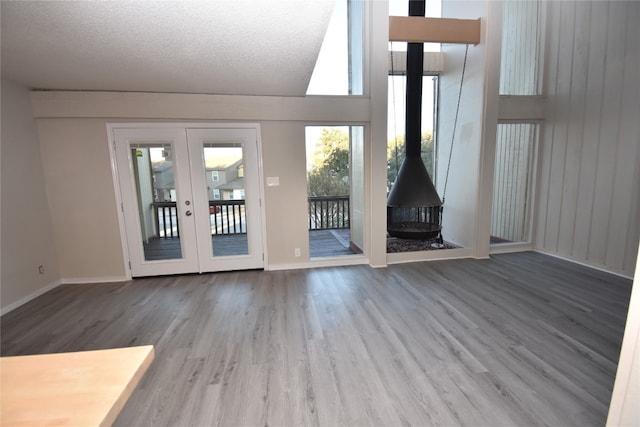 interior space featuring hardwood / wood-style floors, a textured ceiling, and french doors