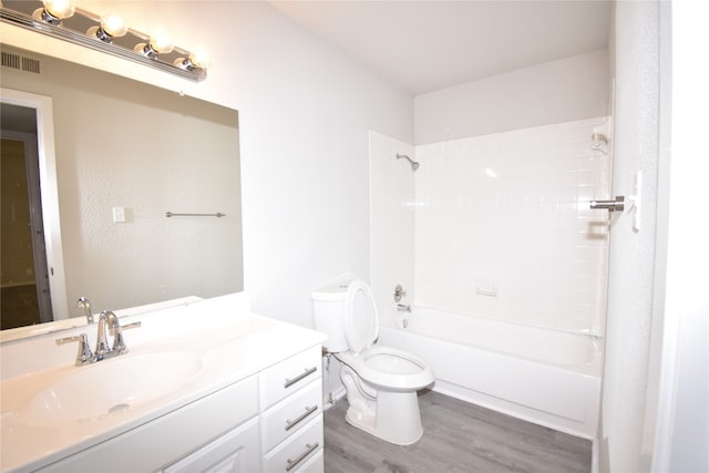 full bathroom featuring toilet, vanity, wood-type flooring, and shower / bathtub combination