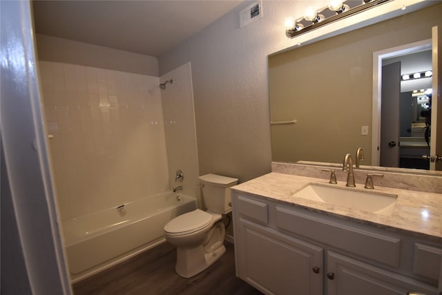 full bathroom with bathtub / shower combination, vanity, wood-type flooring, and toilet