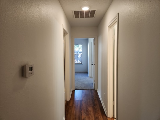 corridor with dark hardwood / wood-style floors