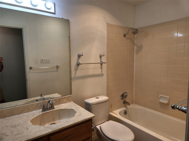 full bathroom featuring vanity, toilet, and tiled shower / bath