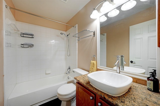 full bathroom featuring vanity, toilet, and tiled shower / bath