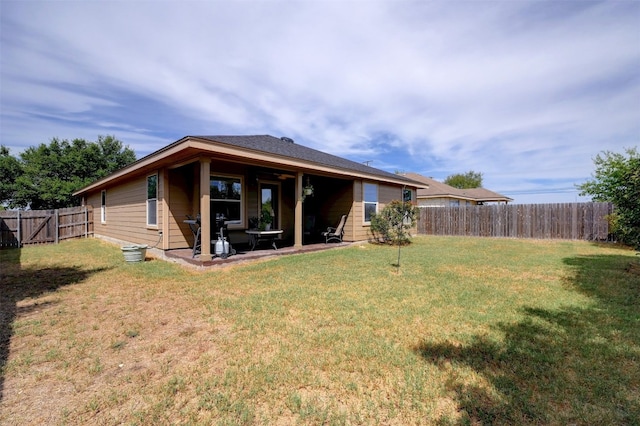 back of property featuring a patio area and a yard