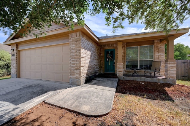 ranch-style home with covered porch and a garage