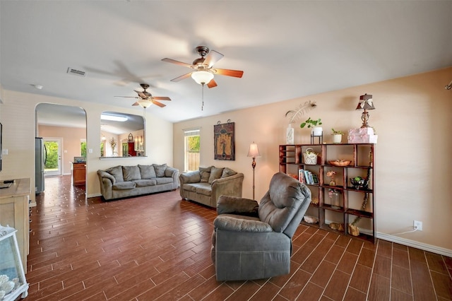 living room with dark hardwood / wood-style floors and ceiling fan