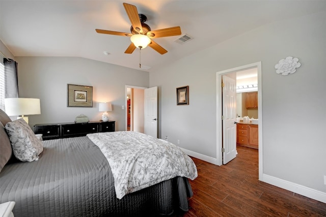 bedroom with ceiling fan, lofted ceiling, ensuite bathroom, and dark hardwood / wood-style floors