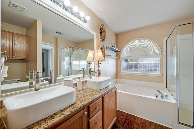 bathroom with vanity, wood-type flooring, and separate shower and tub