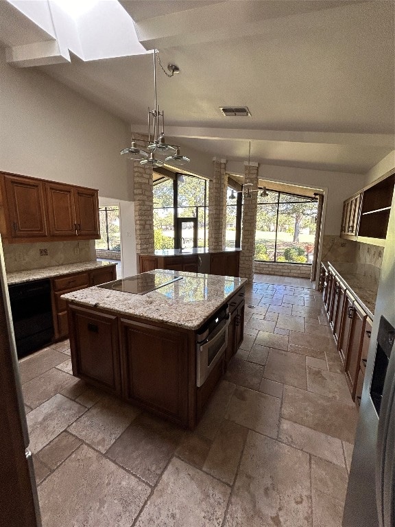 kitchen featuring a wealth of natural light, a center island, decorative light fixtures, and black electric cooktop