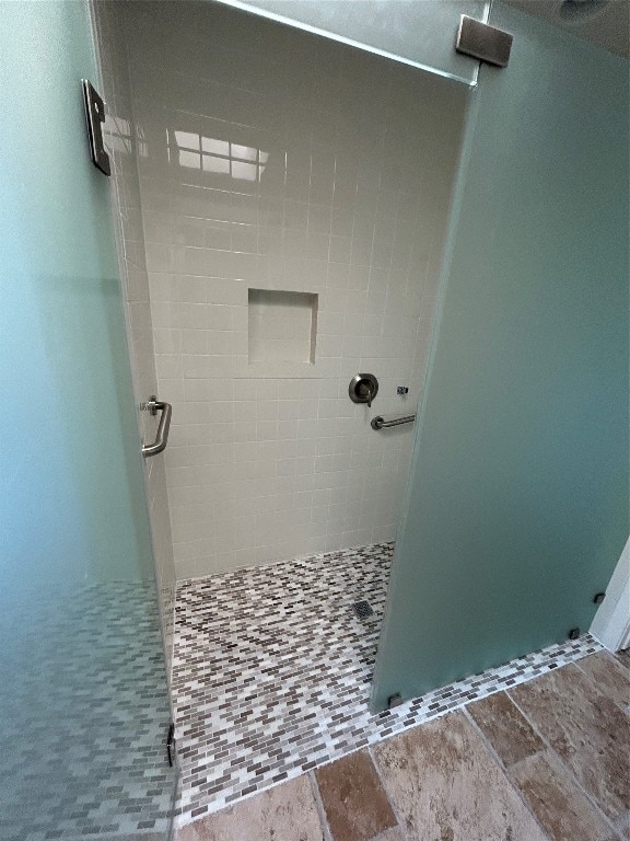 bathroom featuring a shower with door