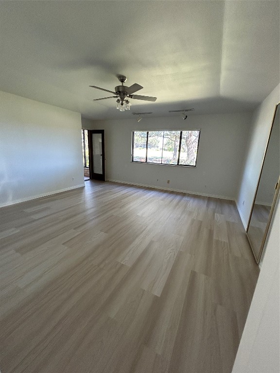 unfurnished room with light hardwood / wood-style flooring and ceiling fan