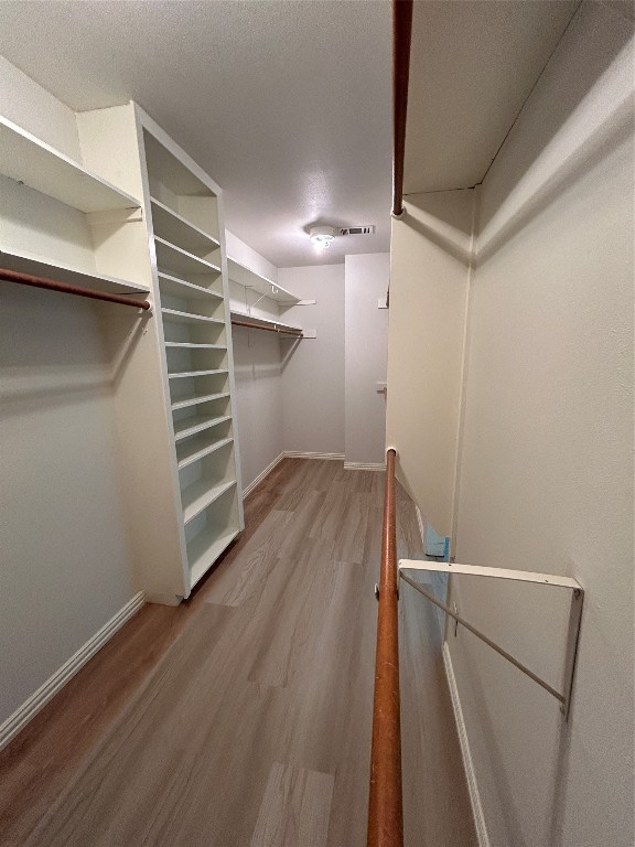 walk in closet featuring wood-type flooring