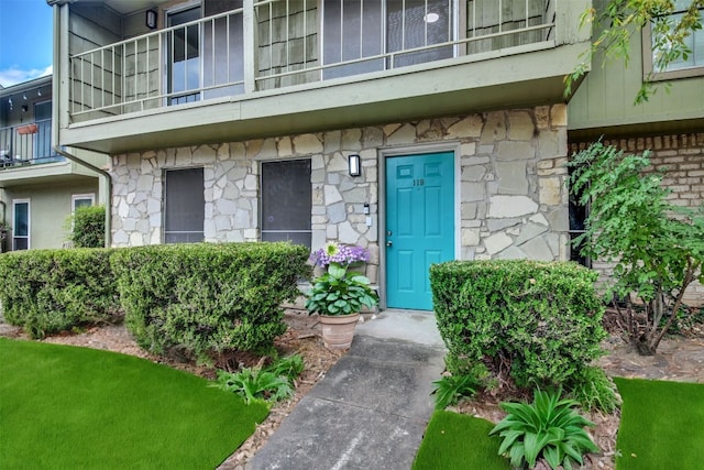 entrance to property with a balcony